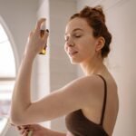 close up photo of woman applying mist